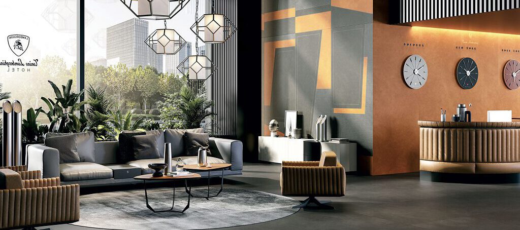 Lobby mit exklusiven Lamborghini-Korium-Fliesen in Großformat 120 × 280 cm, Wandakzente in Orange und Anthrazit für luxuriösen Empfang.