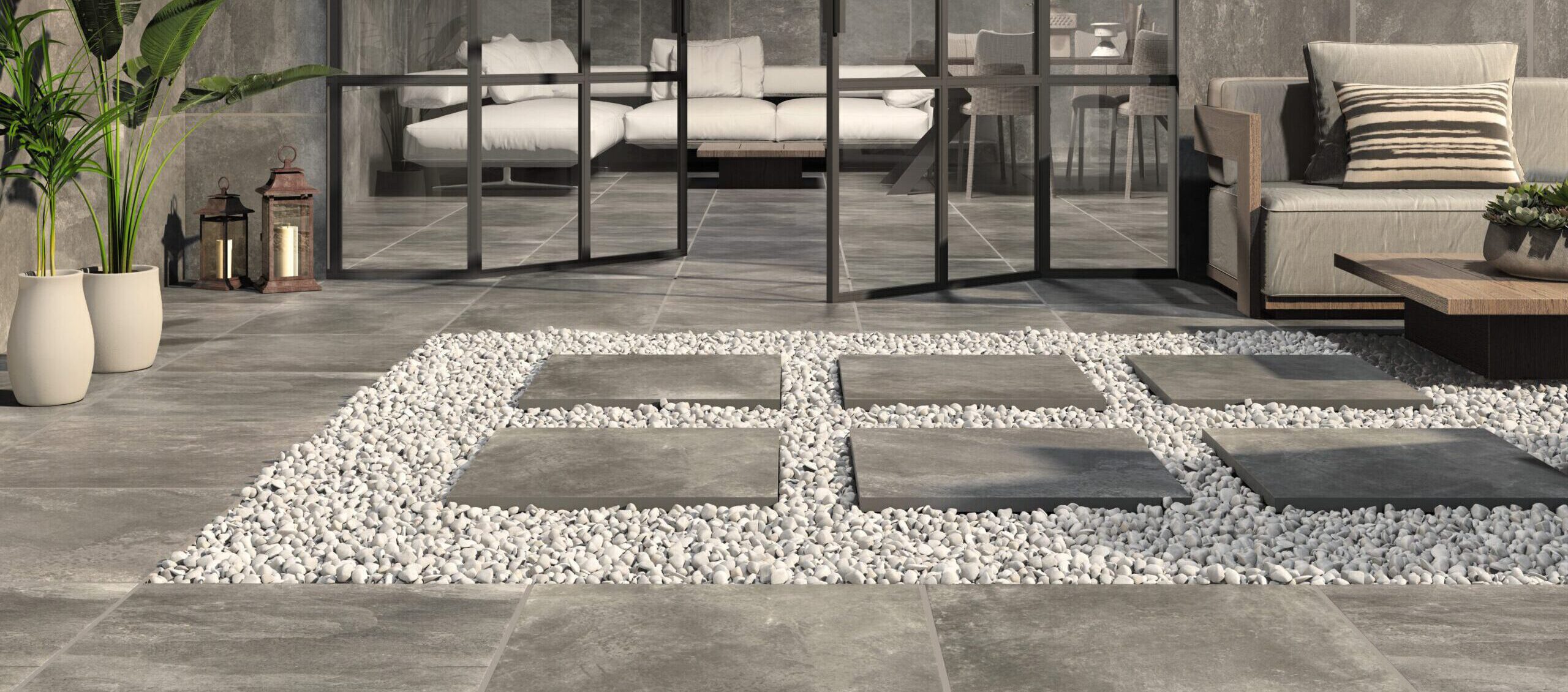 Terrasse mit rutschhemmenden 2 cm starken Feinsteinzeug-Terrassenfliesen 120 × 120 cm in grauer Spachteloptik mit wolkiger Struktur.